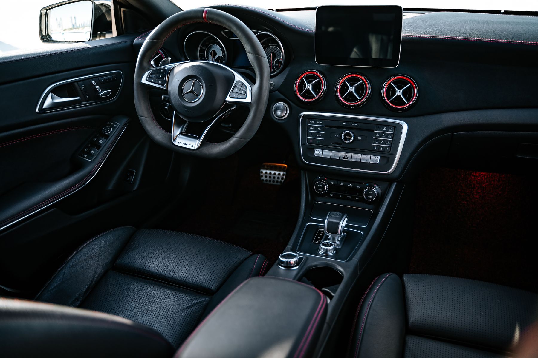 Clean black vehicle interior with dashboard, seats, and console visible